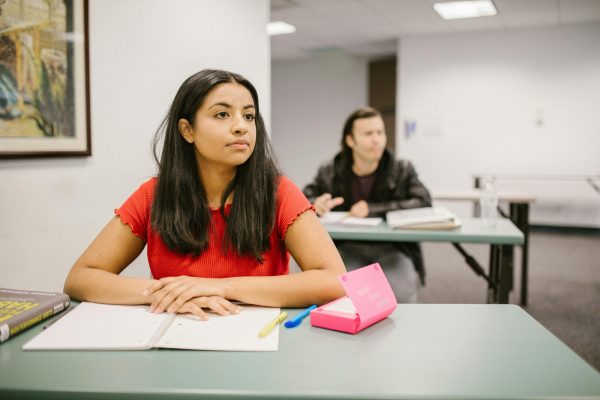 College students attentively listening during a classroom lecture, highlighting education and learning.